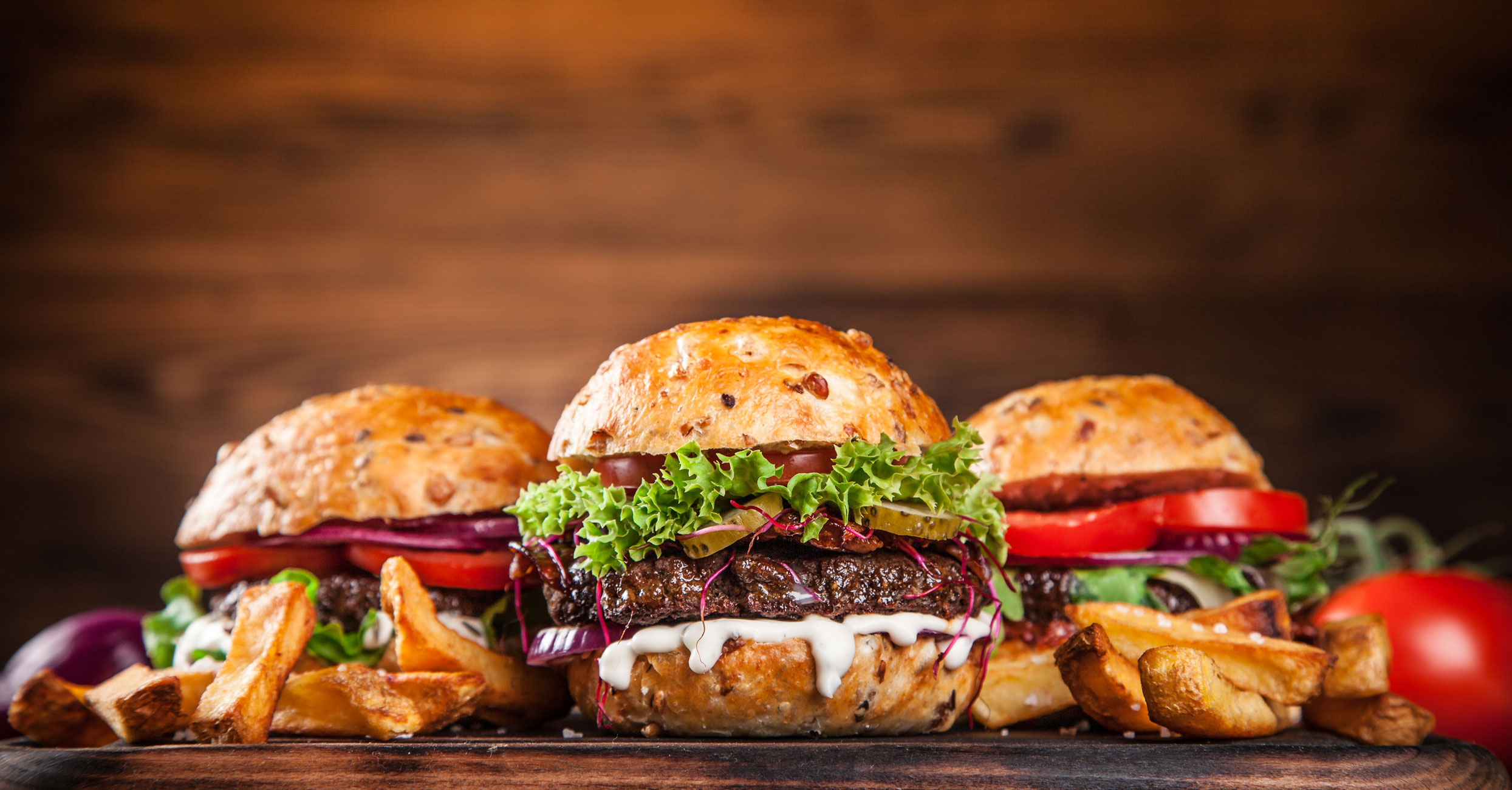 Burgers with lettuce, tomato and toppings